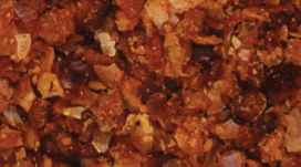 Grade 5 dark coffee-colored DDGS showing potential Maillard reaction heat damage; requires L* color testing for swine and poultry use